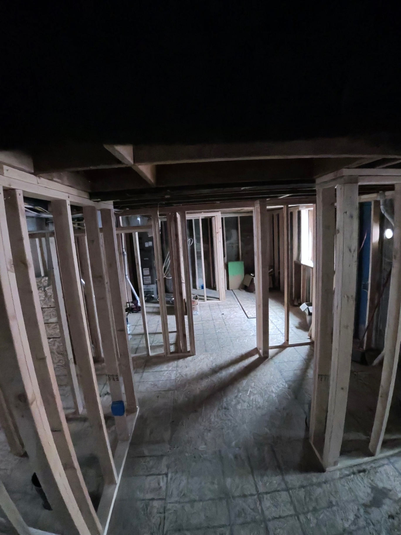 Newly framed interior partitions and doorways inside a remodel in progress.