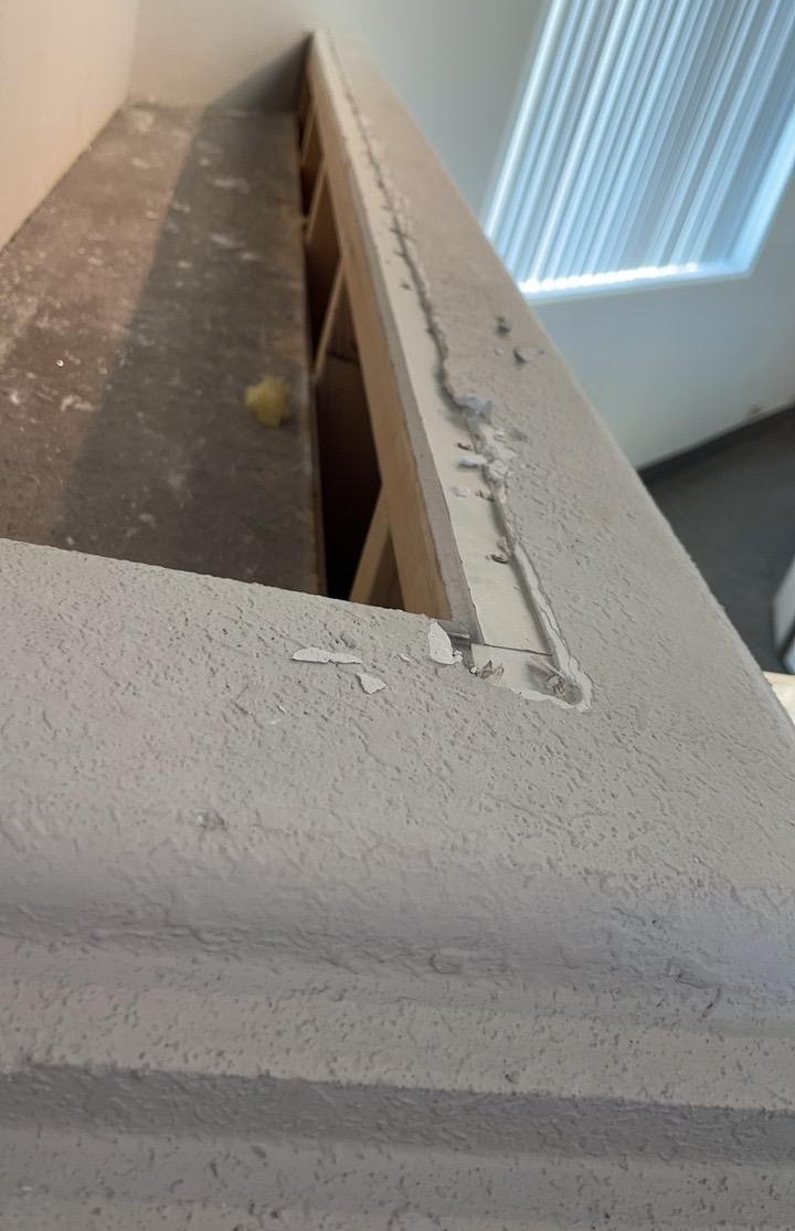 Interior wall cap and trim opened and patched during a commercial building repair.
