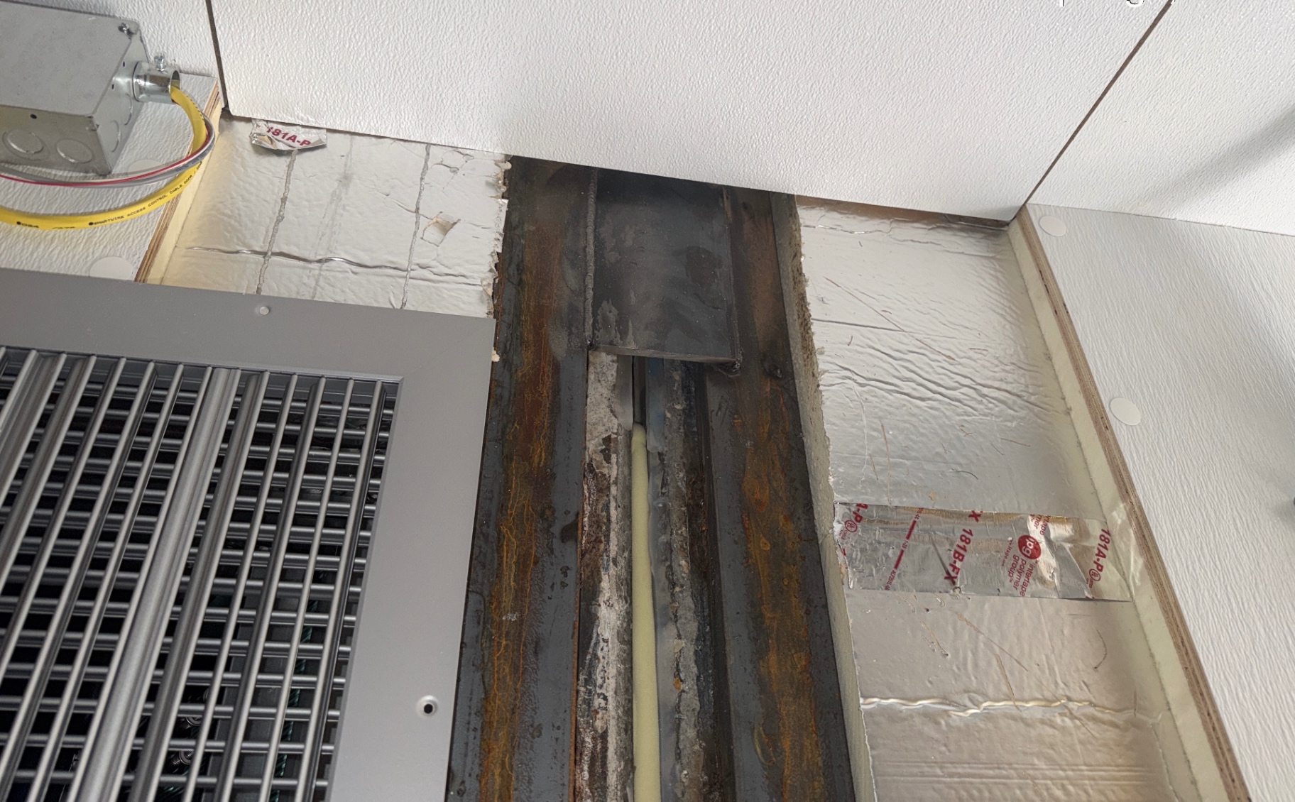 Interior ceiling opened up around structural steel, ductwork and insulation during interior work.