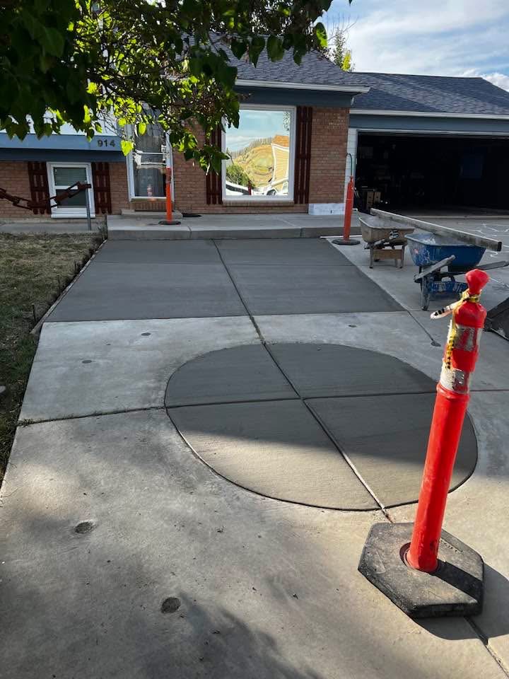 Finished residential concrete driveway with a formed circular section in the center.