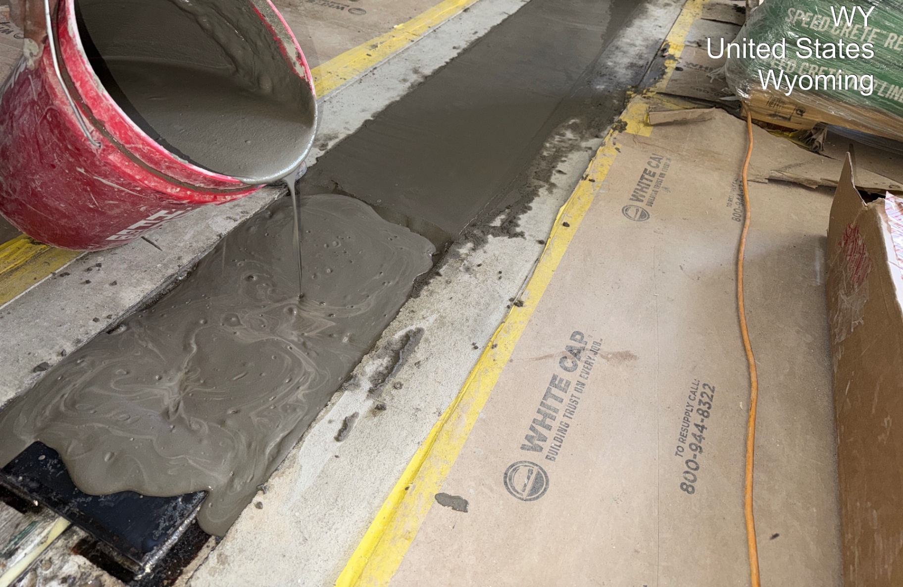 Grout being poured into a formed interior concrete detail on a Wyoming facility project.